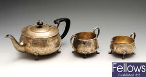 An Arts & Craft style silver three piece tea service, etc.