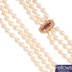 A cultured pearl three-row necklace, with ruby clasp.