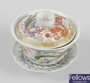 A Chinese famille rose white ground porcelain tea bowl with cover and saucer.