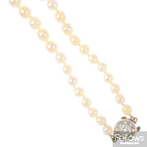 A cultured pearl single-strand necklace, with diamond clasp and separator.