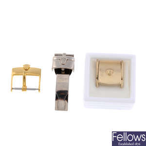 ROLEX - an 18ct white gold deployant clasp together with a 9ct yellow gold clasp and a gold plated clasp.