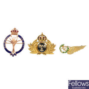 Three military brooches.