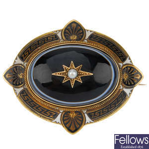 A late Victorian banded agate, enamel and pearl mourning brooch.