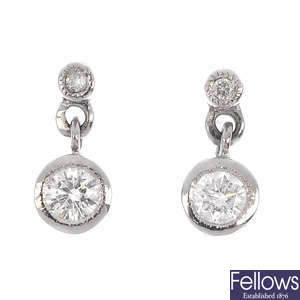 A pair of 18ct gold diamond two-stone drop earrings.