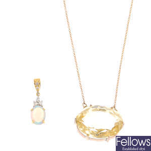 Two gem-set pendants.