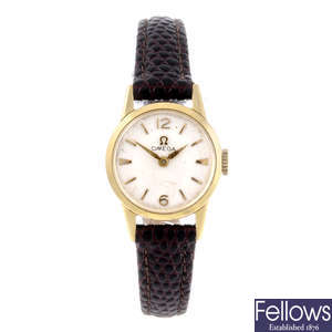 OMEGA - a lady's yellow metal wrist watch together with two yellow gold wrist watches.