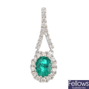 A emerald and diamond pendant.