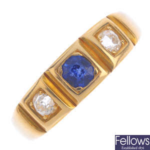 A synthetic sapphire and diamond three-stone ring.