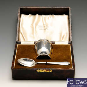 A 1930's cased silver egg cup and spoon and a selection of napkin rings.