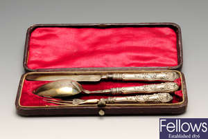 A mid-Victorian cased silver knife, fork and spoon and a 1920's cased set of six silver teaspoons. (2).