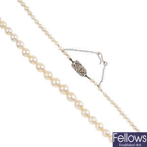 A single-row cultured pearl necklace with diamond clasp.