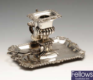 A George IV silver chamberstick.