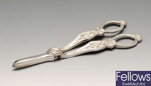 A modern pair of silver grape scissors.