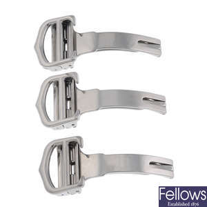 CARTIER - a group of three stainless steel deployant clasps.