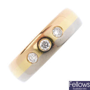 An 18ct gold diamond three-stone band ring.