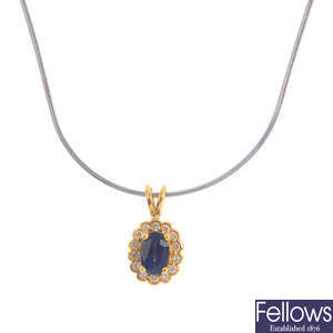 An 18ct gold sapphire and diamond pendant with a chain.