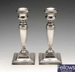 A pair of 1920's silver mounted candlesticks.
