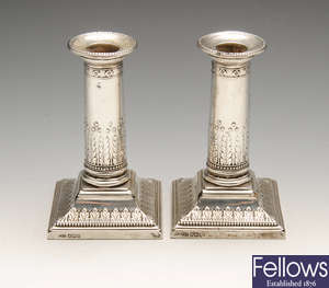 An early twentieth century pair of silver mounted candlesticks.