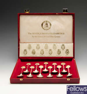 A modern cased set of eleven silver teaspoons commemorating the Silver Jubilee of Elizabeth II, etc.