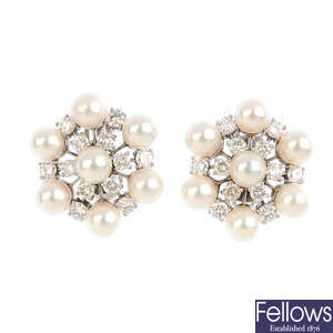 A pair of diamond and cultured pearl cluster earrings.