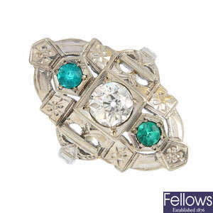 An diamond and synthetic emerald dress ring.