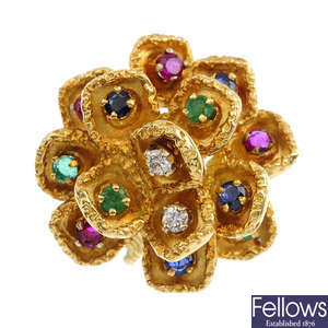 A diamond and gem-set flower ring.