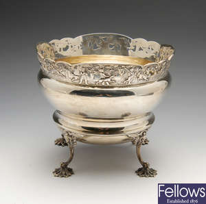 An Edwardian silver fruit bowl with hunting scene border.
