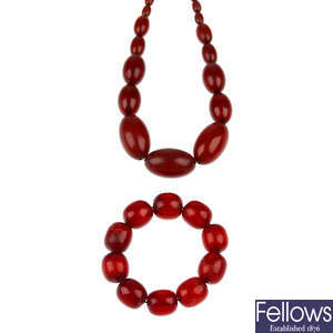 A red plastic bead necklace and bracelet.
