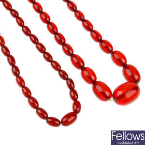 Four red plastic bead necklaces.