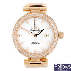 OMEGA - a lady's 18ct rose gold Ladymatic Co-Axial bracelet watch.