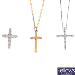 Three gold cross pendants, with two chains.
