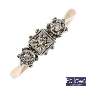 A garnet brooch and a diamond three-stone ring.