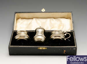 A 1930's cased silver condiment set & assorted napkin rings.