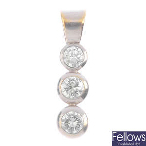 An 18ct gold diamond three-stone pendant.