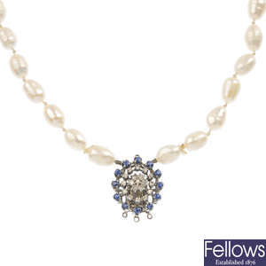 A freshwater cultured pearl two-row necklace, with 14ct gold sapphire and diamond clasp.