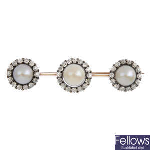 An Edwardian pearl and diamond triple cluster brooch.