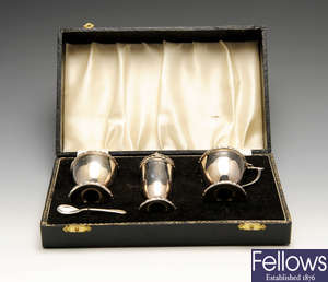 A 1960's cased silver condiment set, a 1960's silver pepper mill and a cased set of six silver coffee bean spoons. (3).