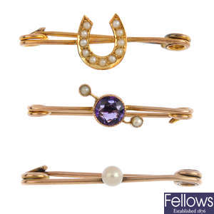 Four early 20th century gold brooches and one clasp.