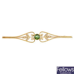 An Edwardian 15ct gold tourmaline and seed pearl brooch.