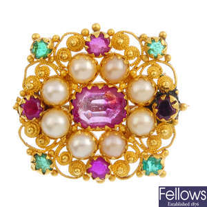 A gem-set filigree brooch.