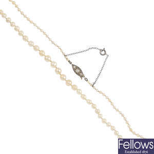 A natural pearl single-strand necklace, with diamond clasp.