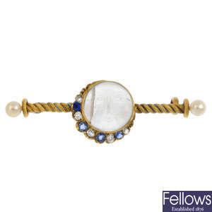 An early 20th century gold 'man in the moon' moonstone, diamond and gem-set brooch.