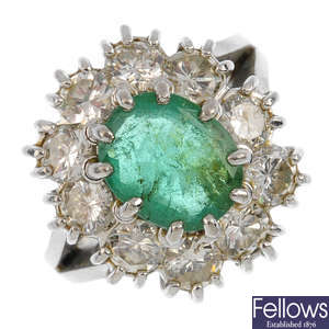 An emerald and diamond cluster ring.