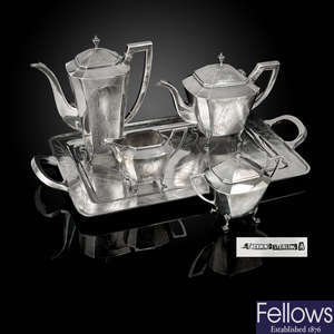 A turn of the century Chinese export silver four piece tea service and matching twin-handled tray.