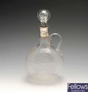 A Victorian silver mounted glass claret jug.