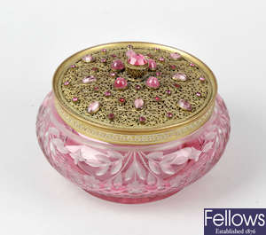 A pink cut glass lady's vanity jar and cover.