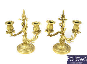 A pair of 19th century twin branch ormolu candelabra modelled in the Rococo style.