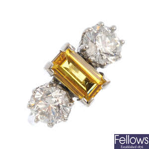An 18ct gold yellow sapphire and diamond three-stone ring.