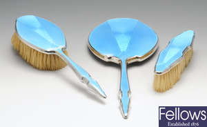 A 1930's three piece silver mounted and enamel dressing table set.