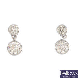 A pair of diamond two-stone drop earrings.